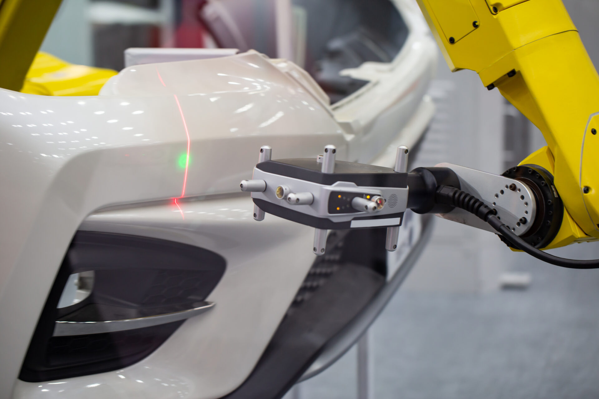 A robotic arm scanning a car part