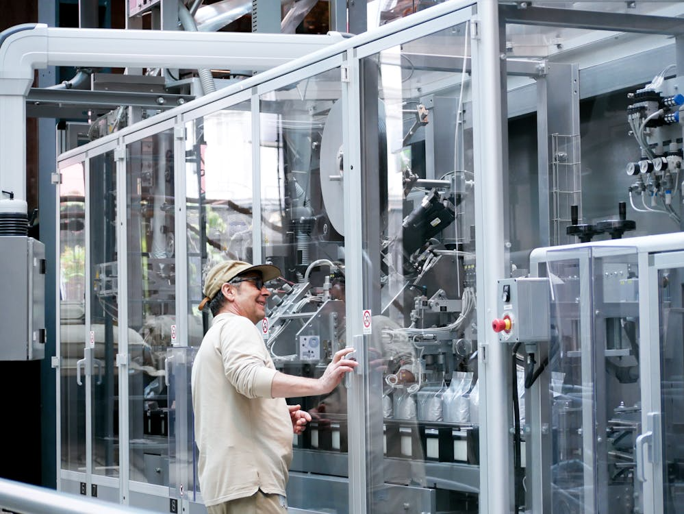 A man observing a coffee packaging operation